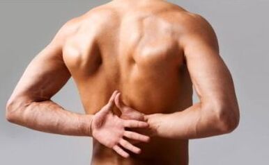 A man has back pain at the bottom of the shoulder blade